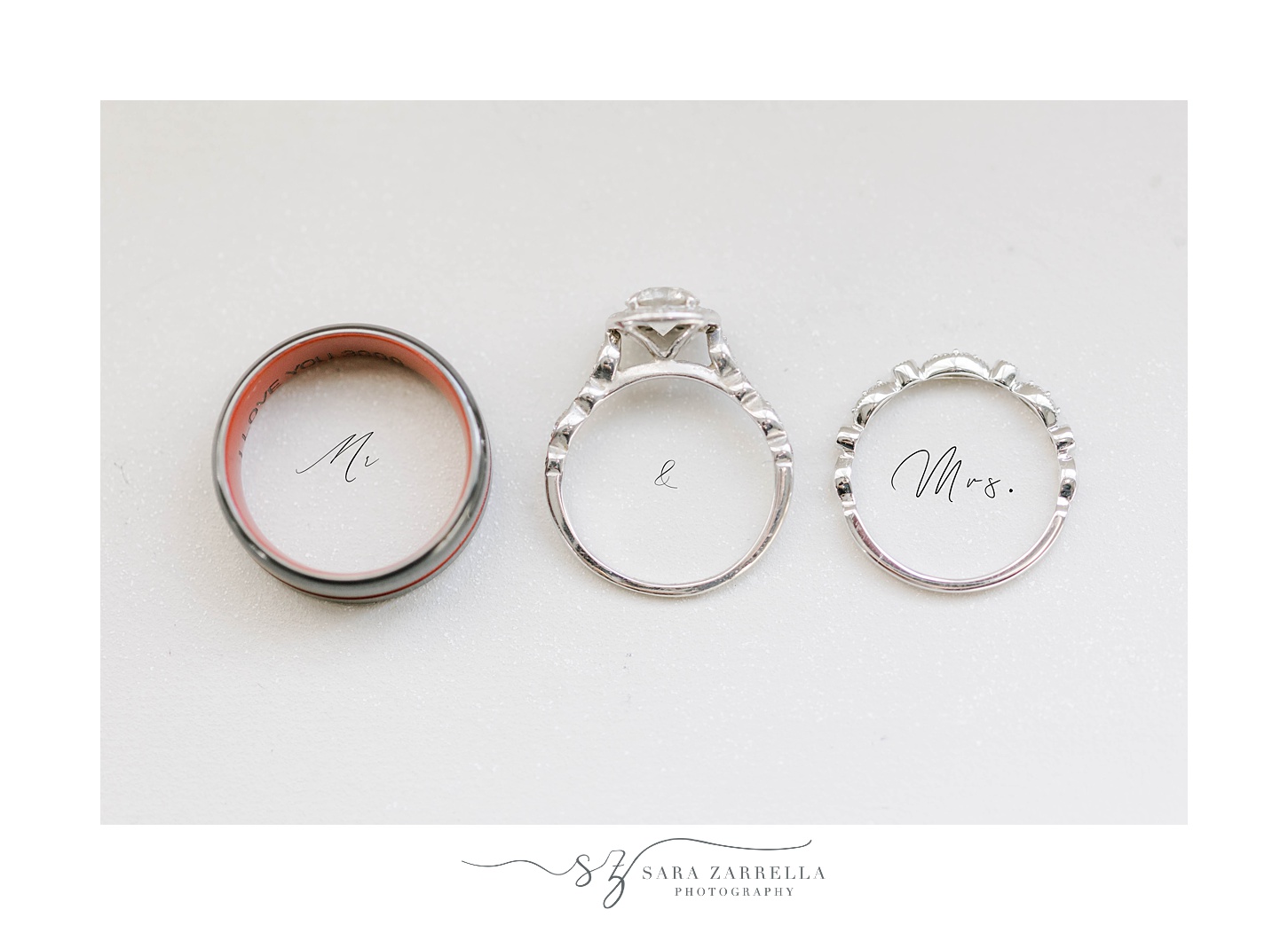 wedding rings lay above Mr & Mrs wording 
