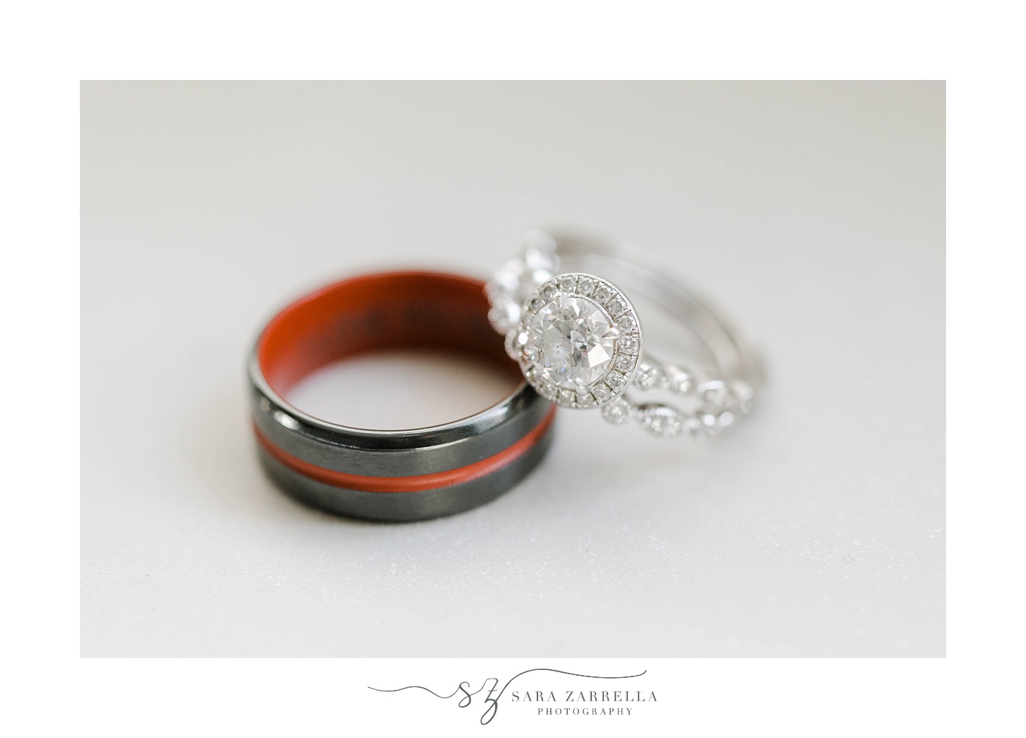diamond band leans on groom's red and black ring