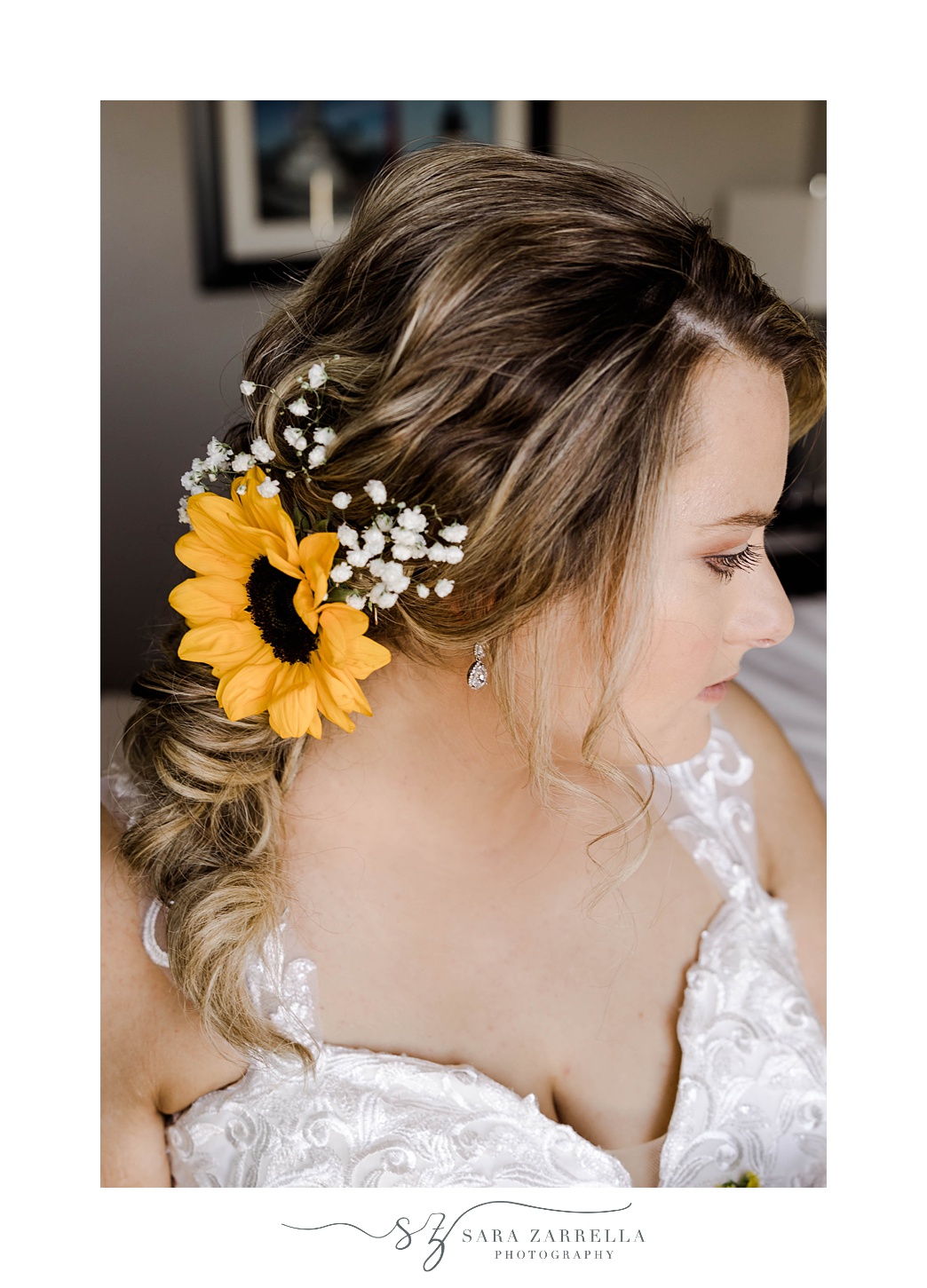 bride looks over shoulder showing off sunflower and baby's breath in hair 
