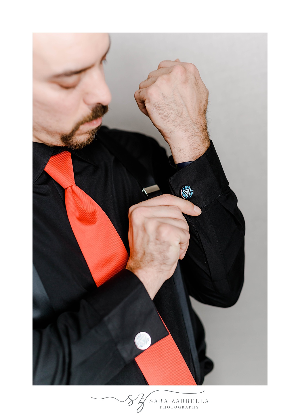 groom adjusts custom Marvel cufflinks 