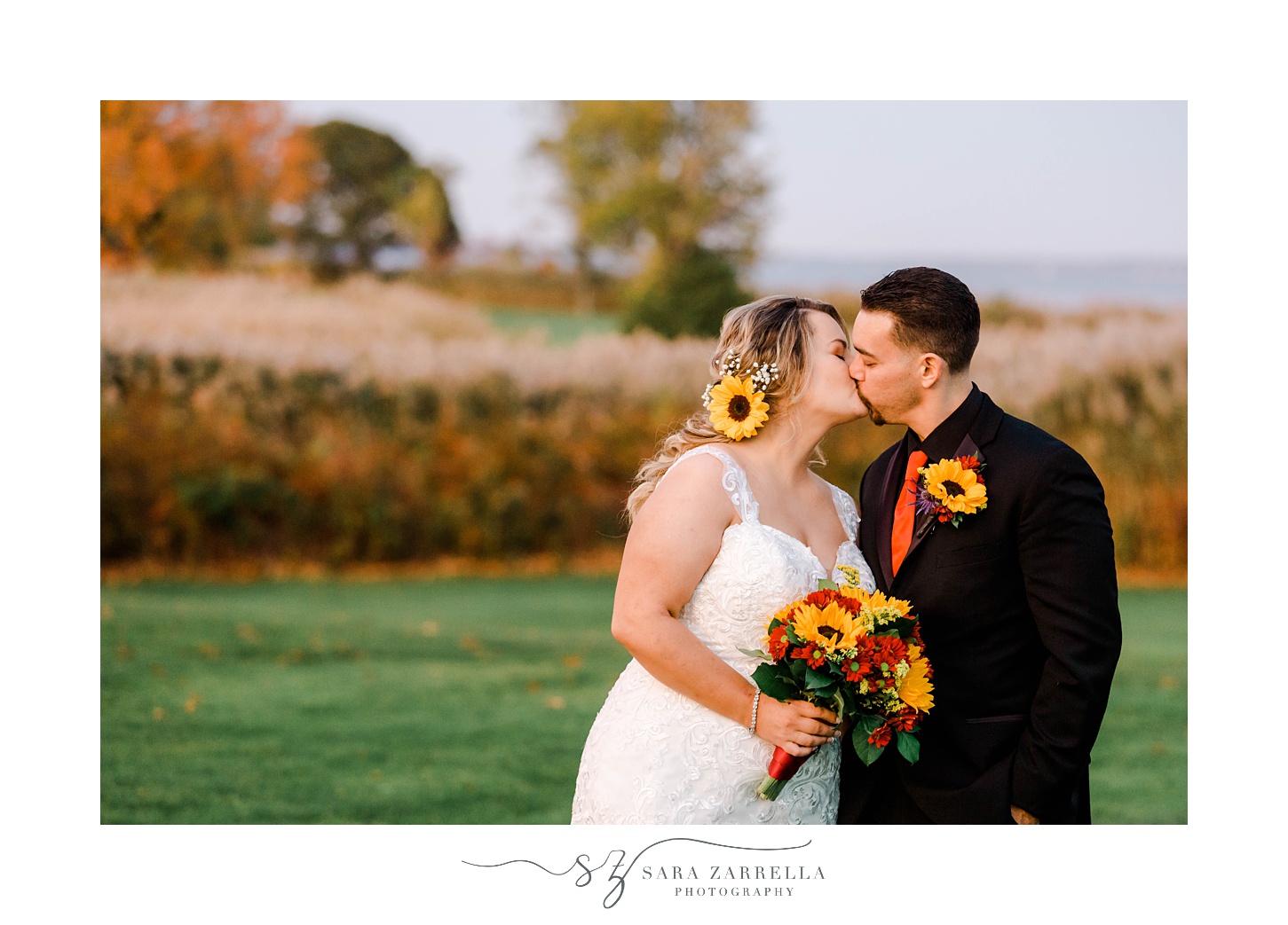 bride and groom kiss while she holds bouquet of sunflowers 