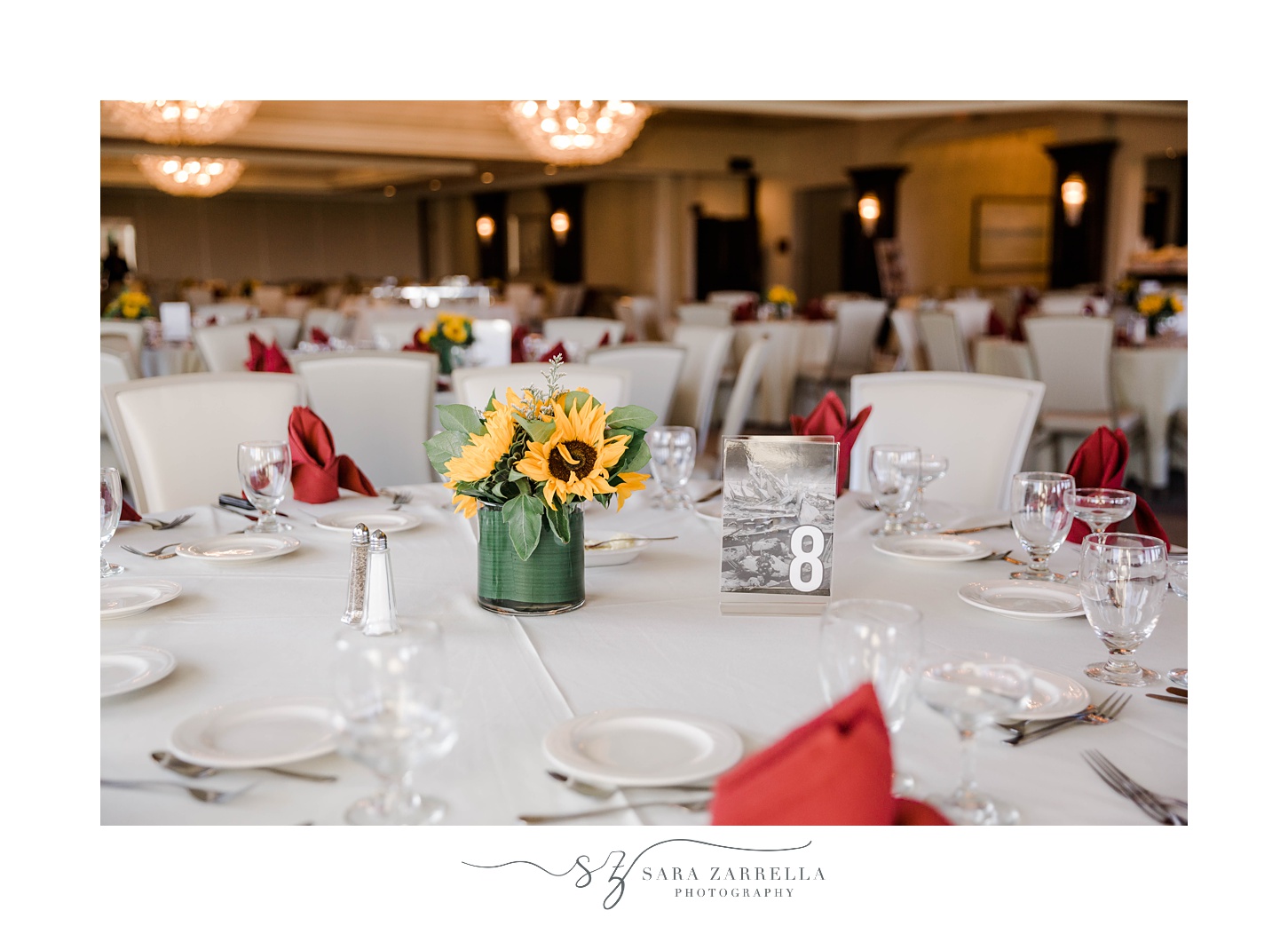 wedding reception at Quidnessett Country Club with red napkins and sunflower centerpieces 