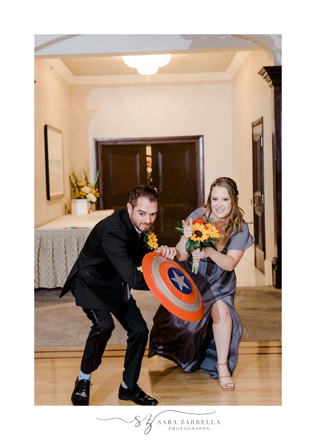 bridesmaid and groom enter wedding reception with Marvel props 