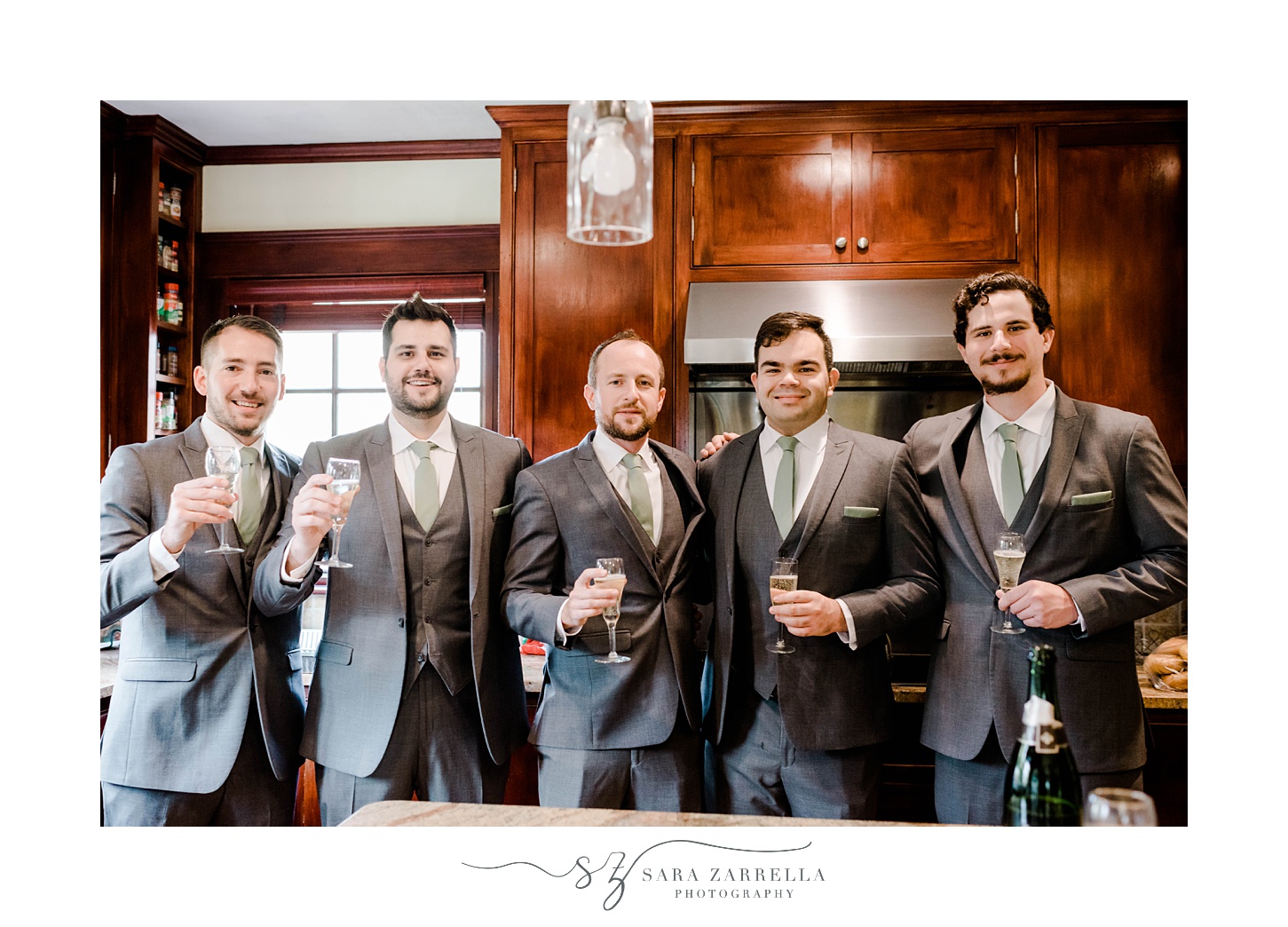 groom and groomsmen pose with drinks in Rhode Island home