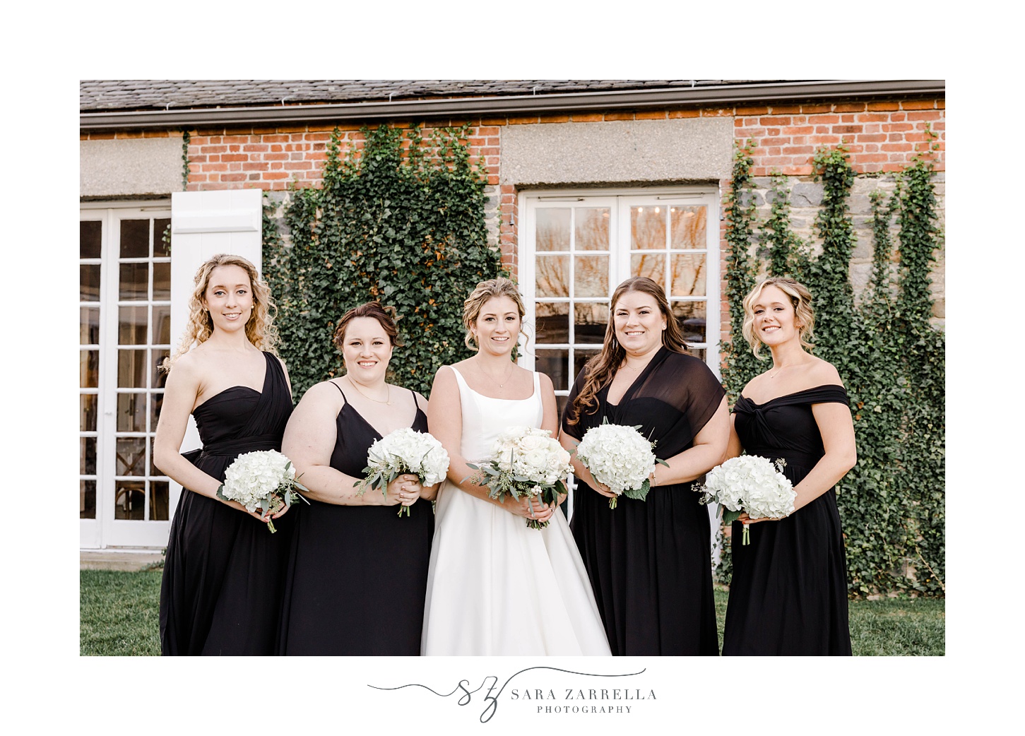 bride stands with bridesmaids in black dresses outside Shepard's Run
