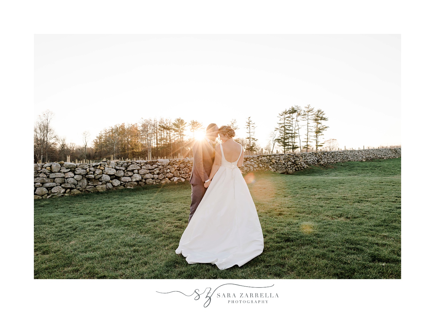 bride and groom hug by stone wall at Shepard's Run