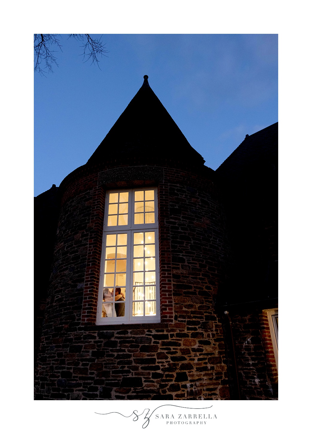 nighttime portrait of bride and groom kissing in window at Shepard's Run