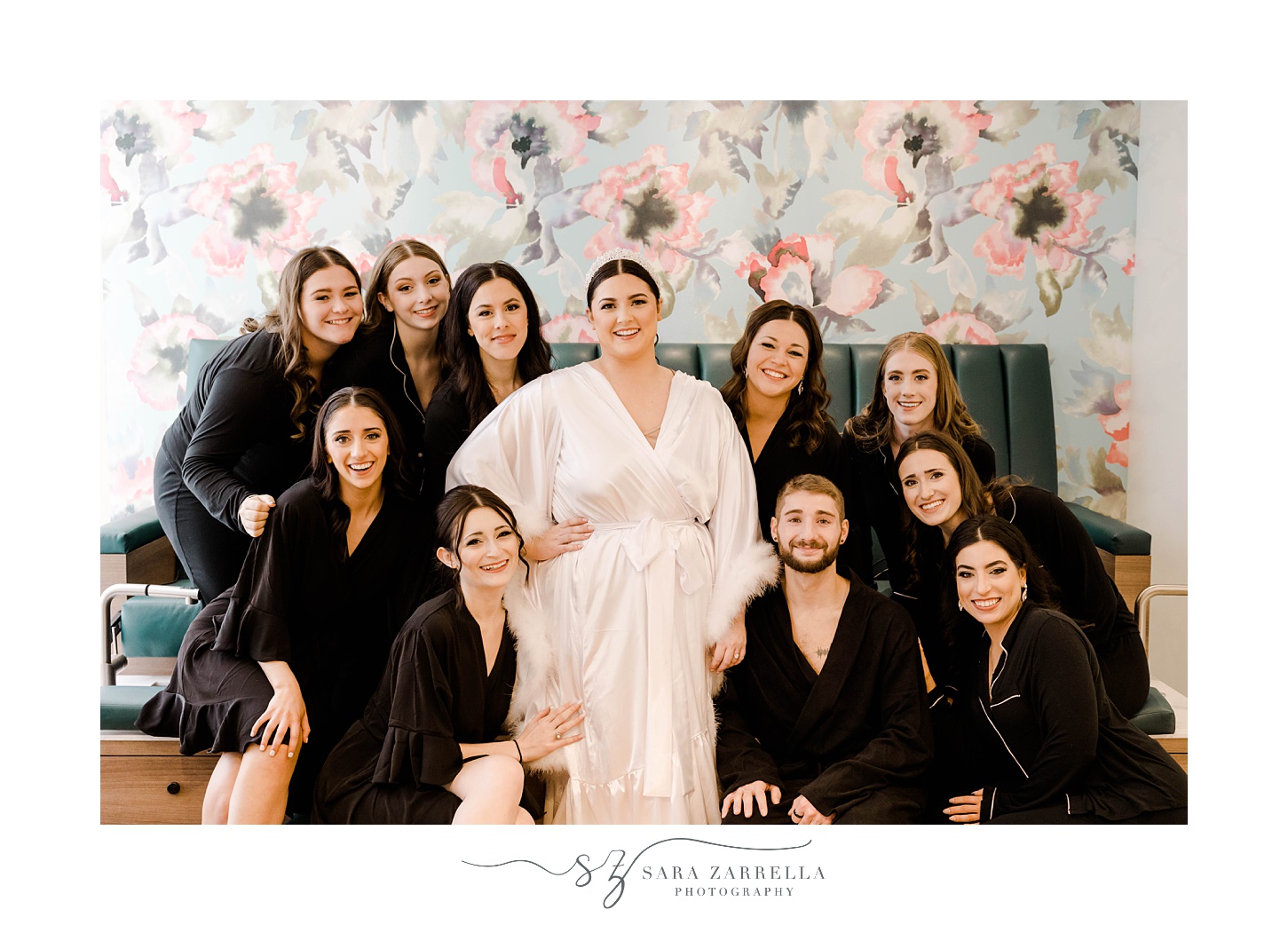 bride poses with bridal party in black robes at The Graduate Providence 