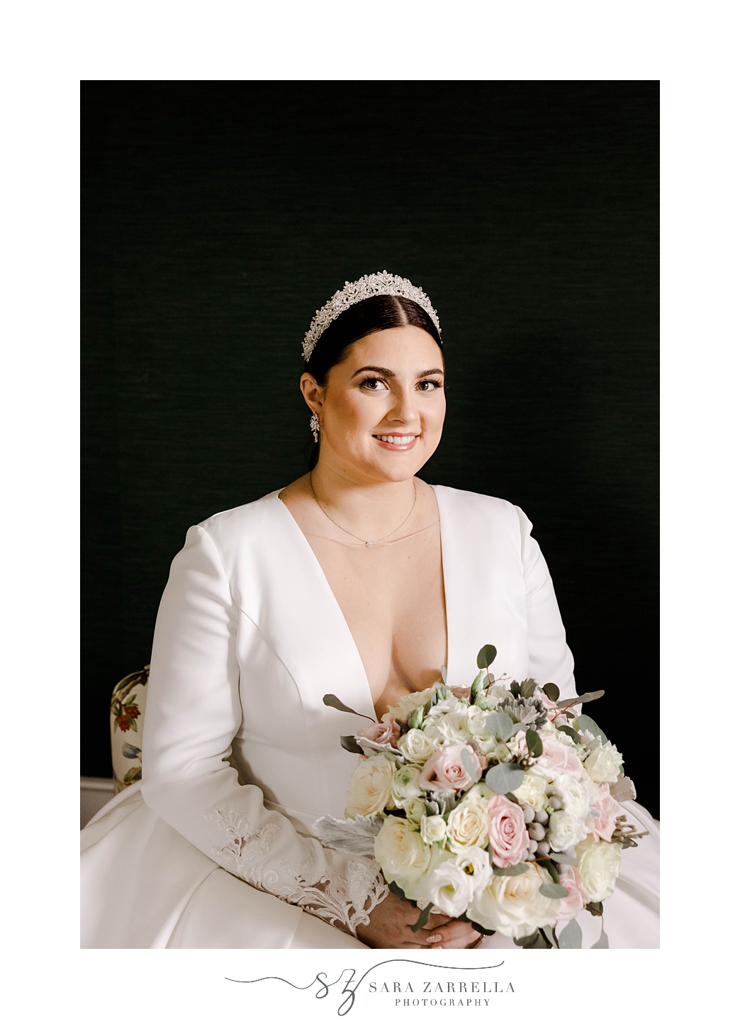 winter bride smiles holding bouquet of pink and white flowers 