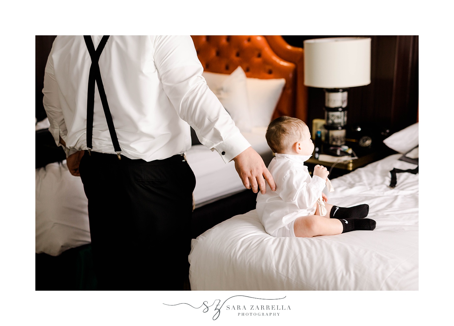groom talks to baby during prep at The Graduate Providence 