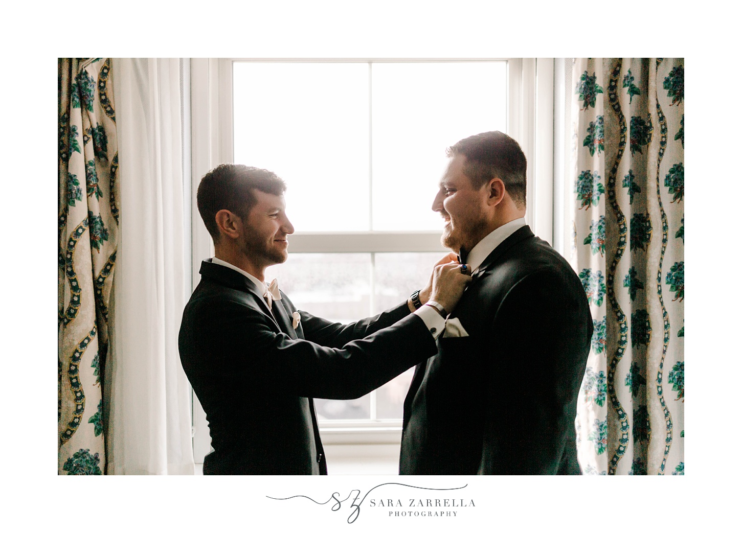 groomsman helps groom adjust tie in suite at The Graduate Providence 