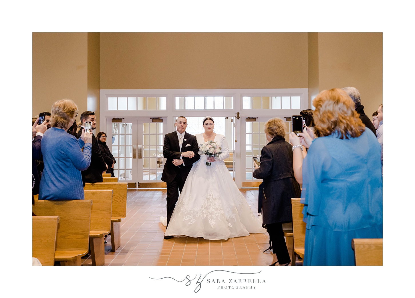 bride and father walk down aisle at traditional church wedding in Providence, RI
