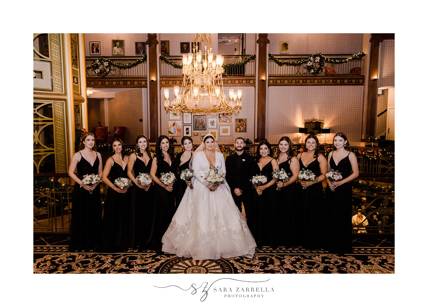 bride stands with bridal party in black attire at The Graduate Providence 