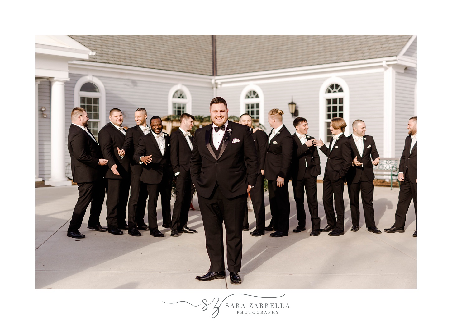 groom poses with groomsmen outside Rhode Island church 