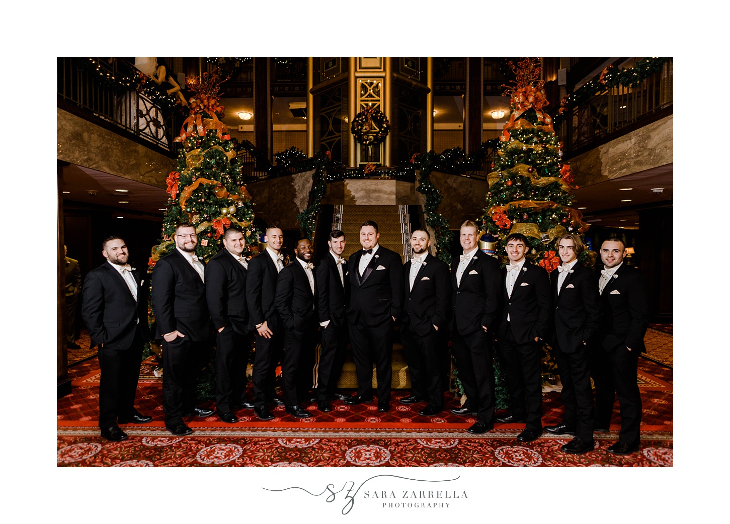 groom and groomsmen pose at staircase in The Graduate Providence