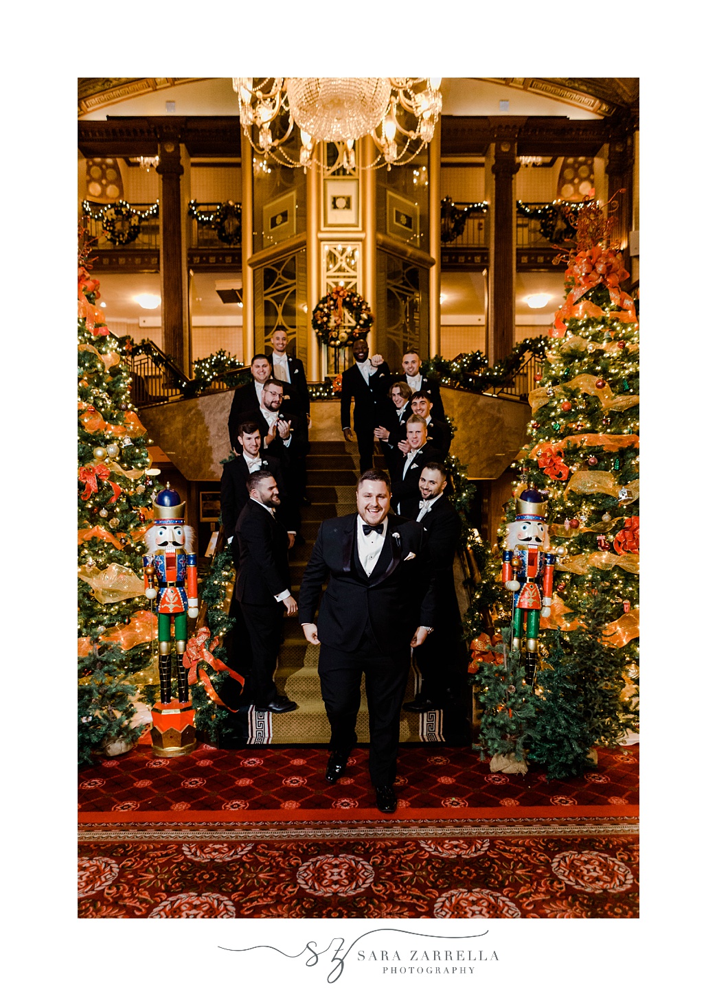 groom and groomsmen line steps between Christmas trees at The Graduate Providence