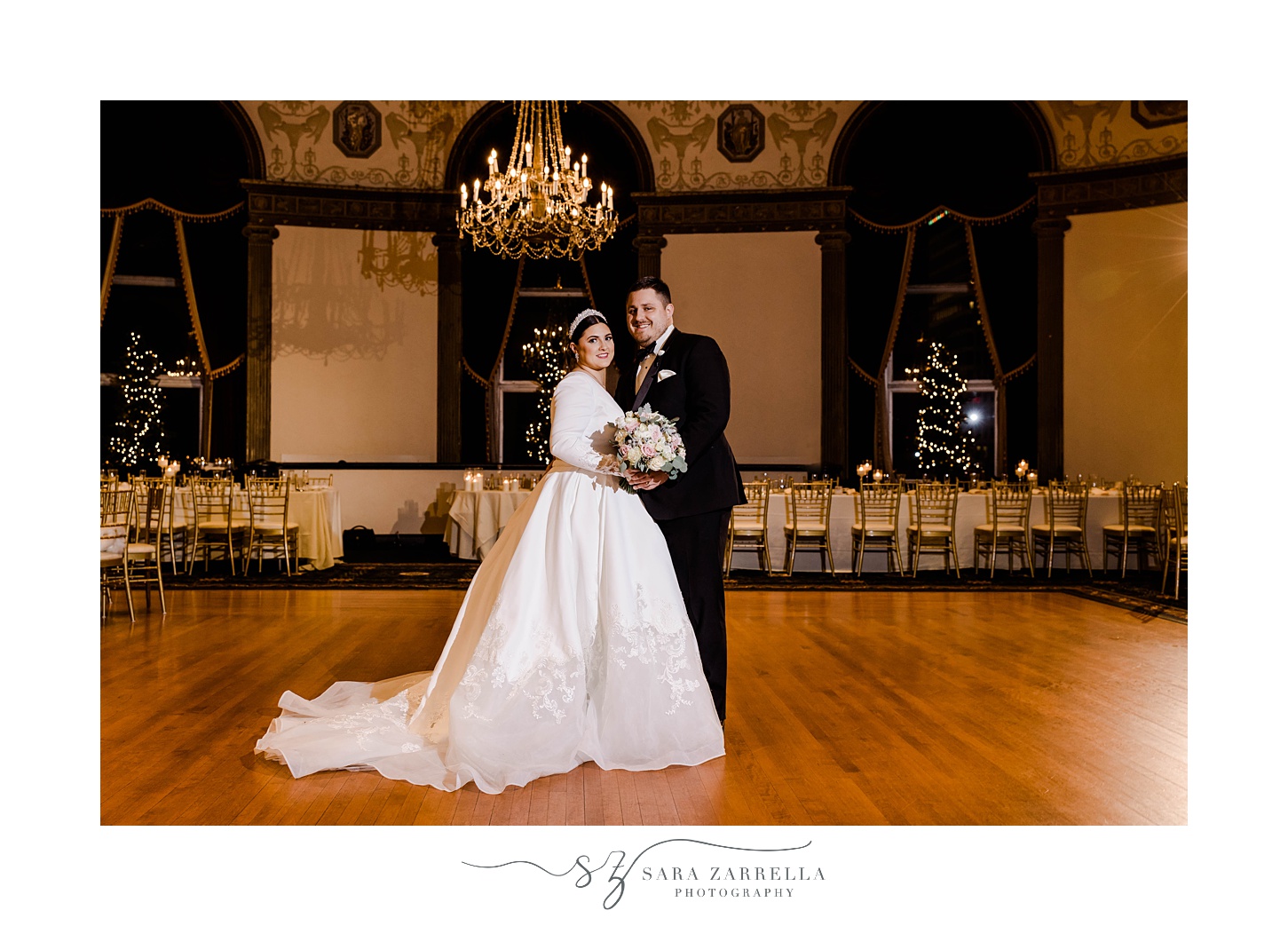 newlyweds hug standing in ballroom of The Graduate Providence