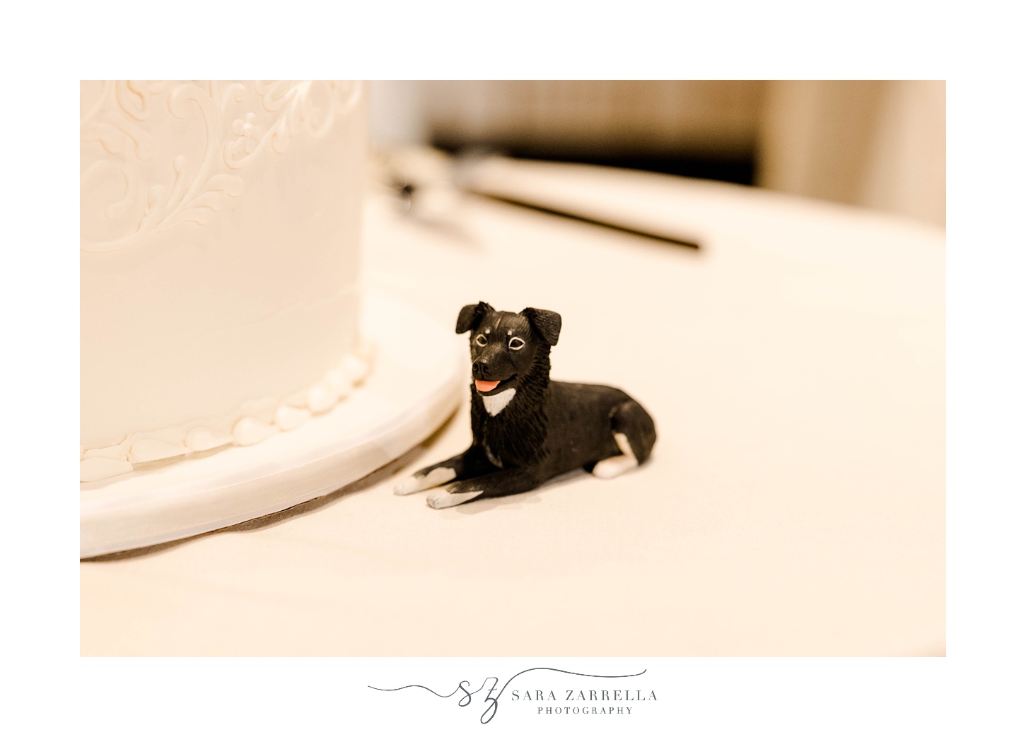 fondant dog sits by wedding cake 