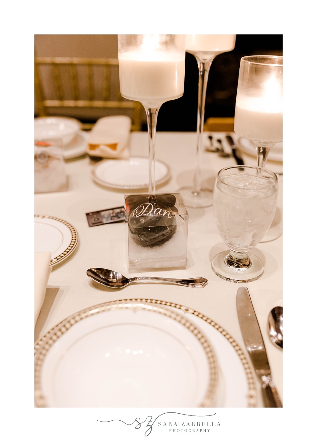 place setting with white and gold plates and chocolate bomb 