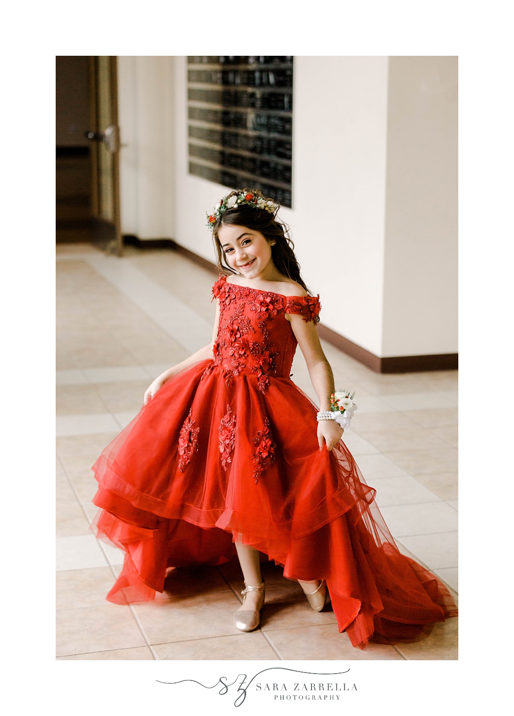 girl in red dress poses in hallway at church 