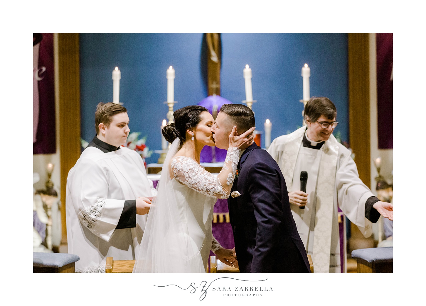 bride and groom kiss during traditional Catholic ceremony in Rhode Island