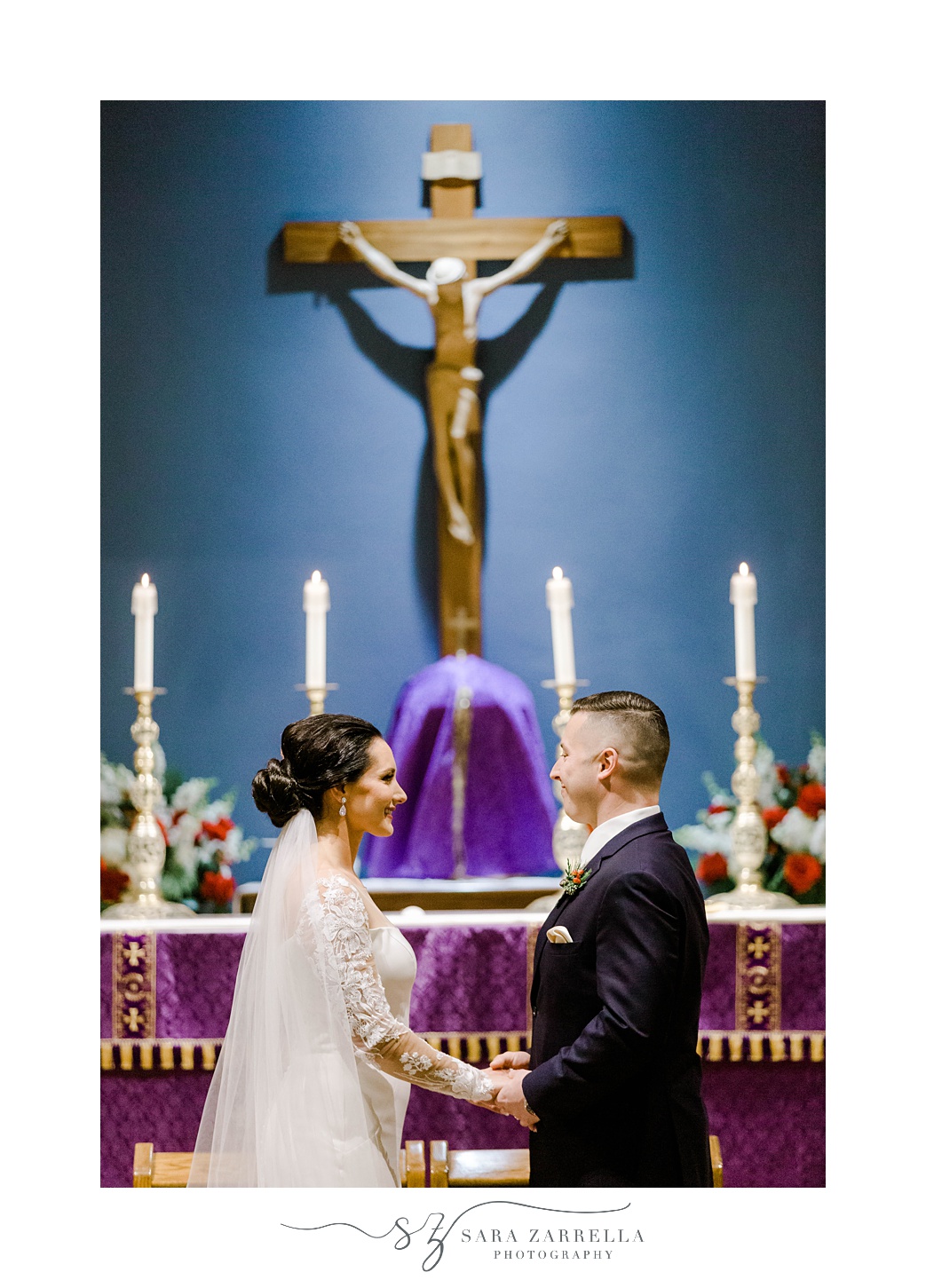 newlyweds smile at each other after traditional Catholic ceremony in Rhode Island