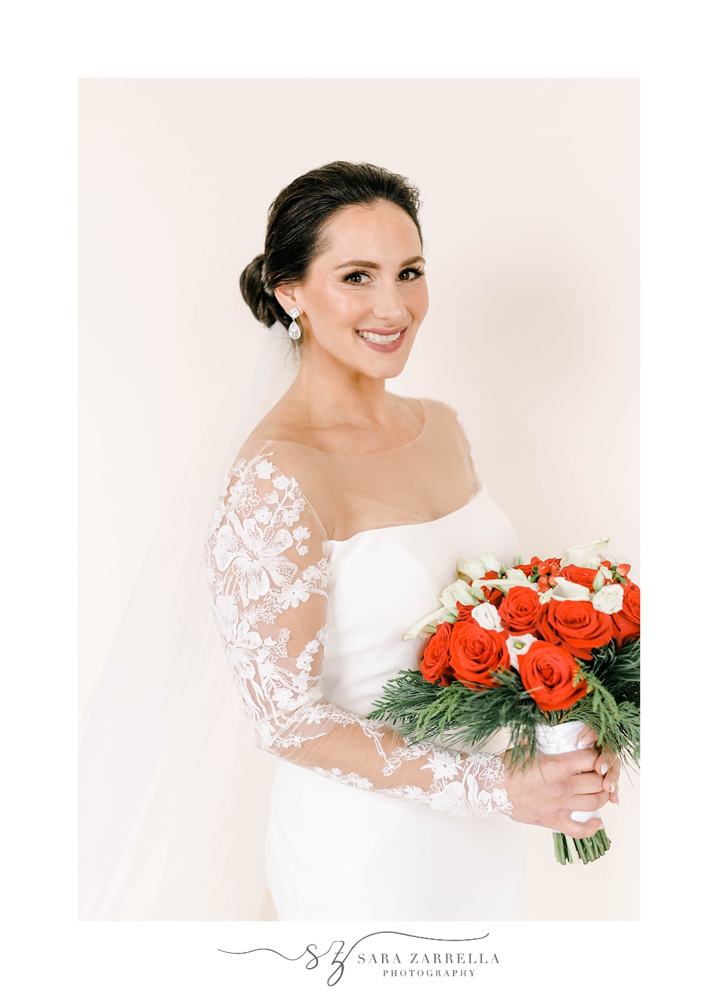winer bride holds bouquet of red roses with baby's breath 