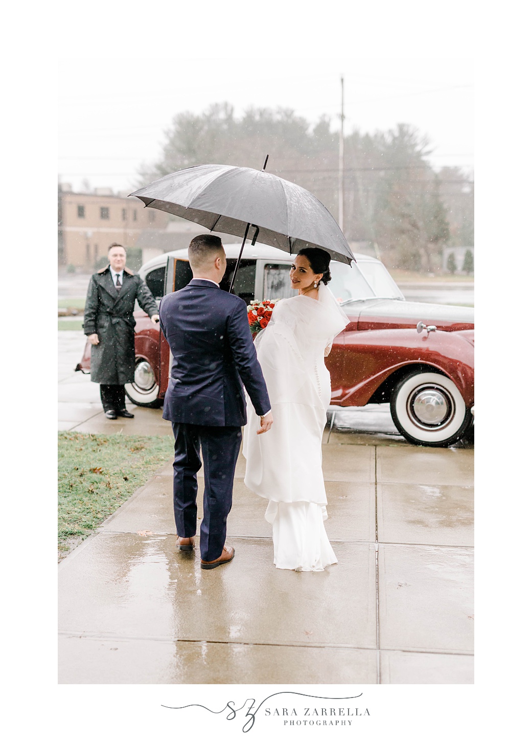 newlyweds leave church under umbrella on rainy wedding day