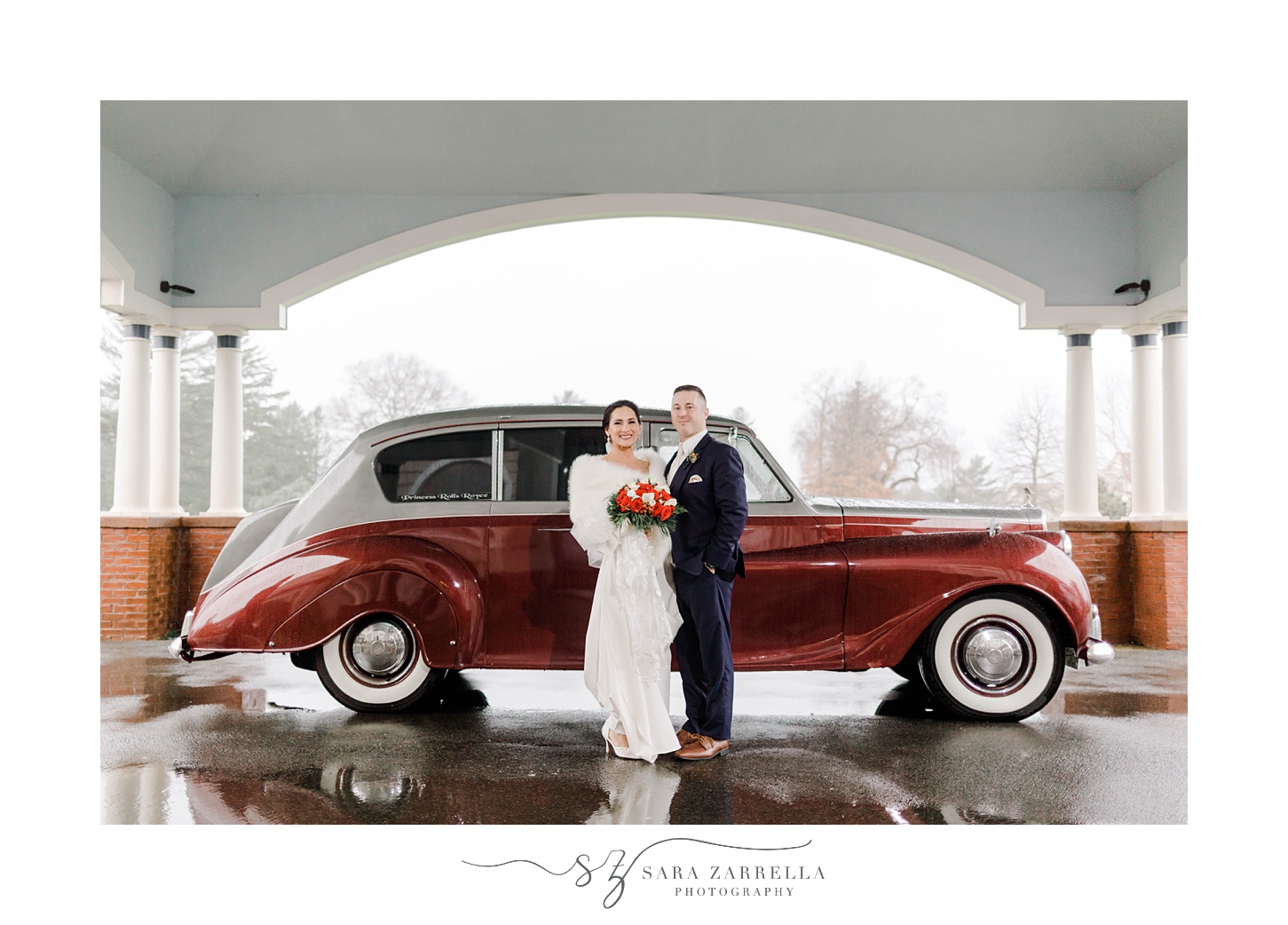 bride and groom stand by classic 1937 Cranberry Rolls Royce Limo 