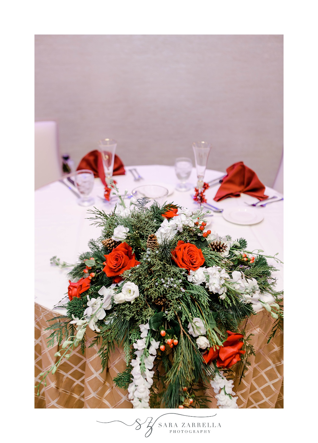 sweetheart table with red and white floral display at Quidnessett Country Club