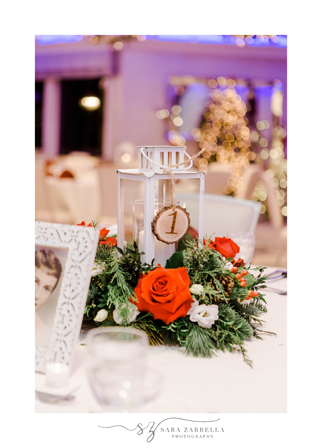 lantern with rustic table number and red and white flowers at Quidnessett Country Club