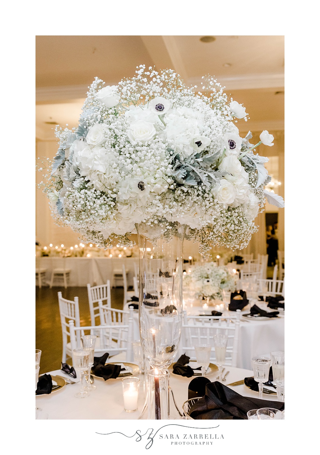 tall centerpiece with white and black flowers 