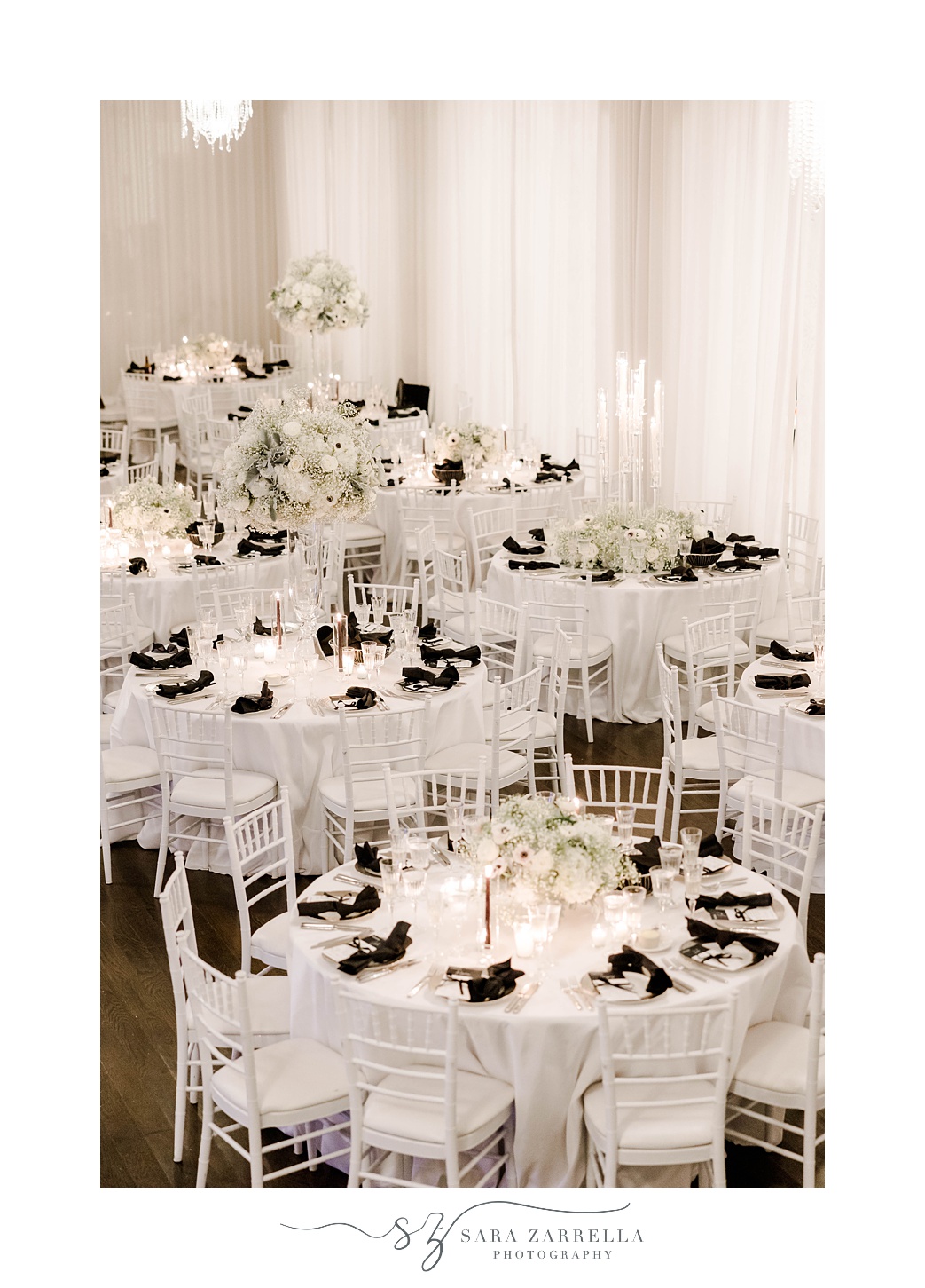 tables with black napkins and floral centerpieces for NYE wedding at Belle Mer