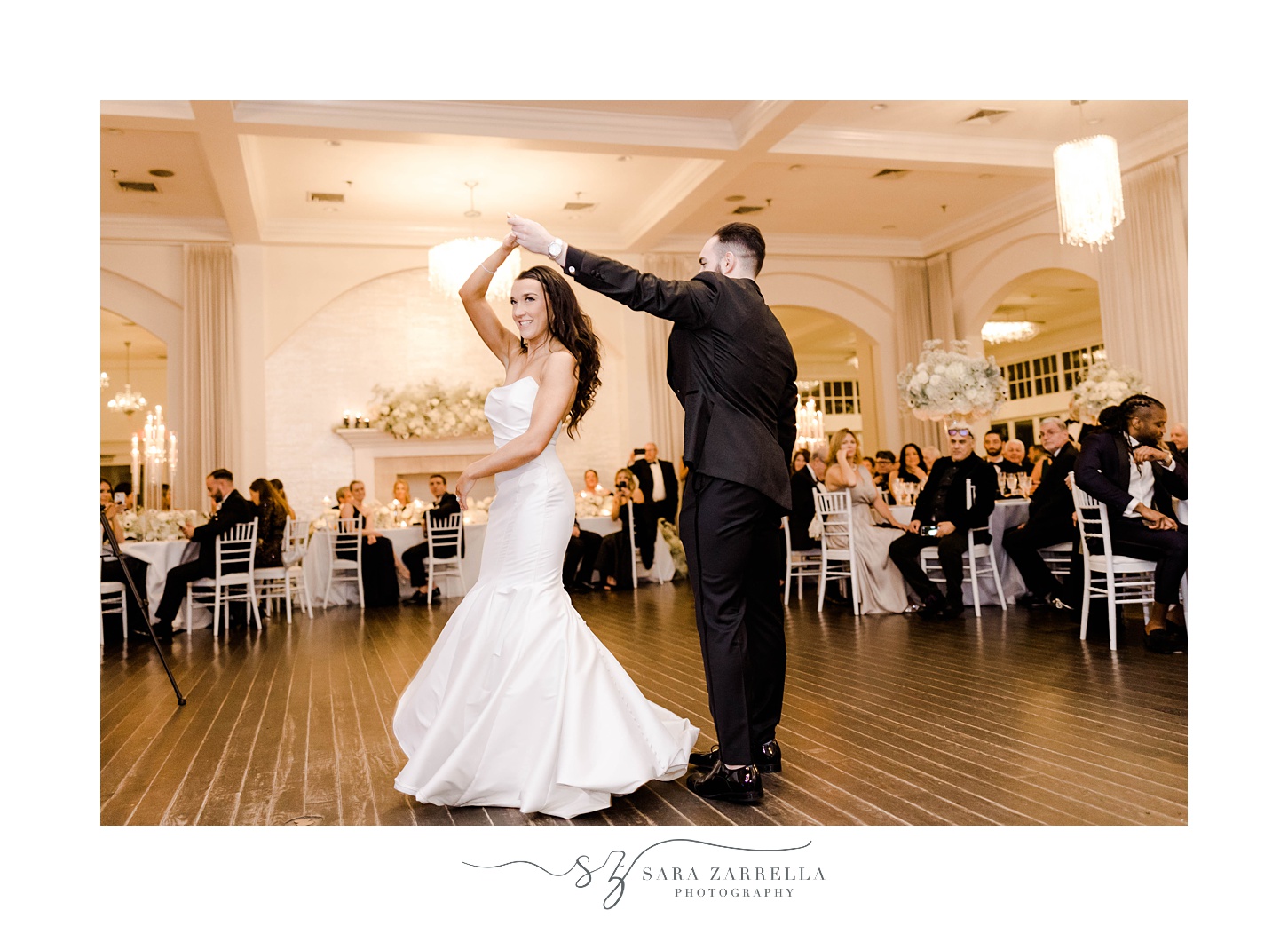 groom twirls bride during first dance at NYE wedding at Belle Mer