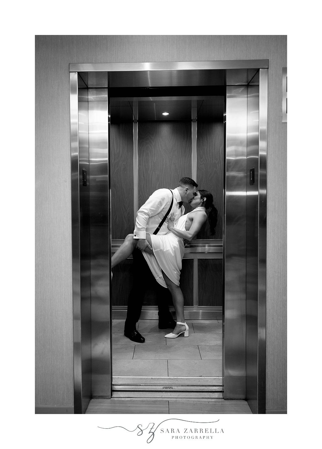 newlyweds kiss in elevator at the Crowne Plaza Warwick