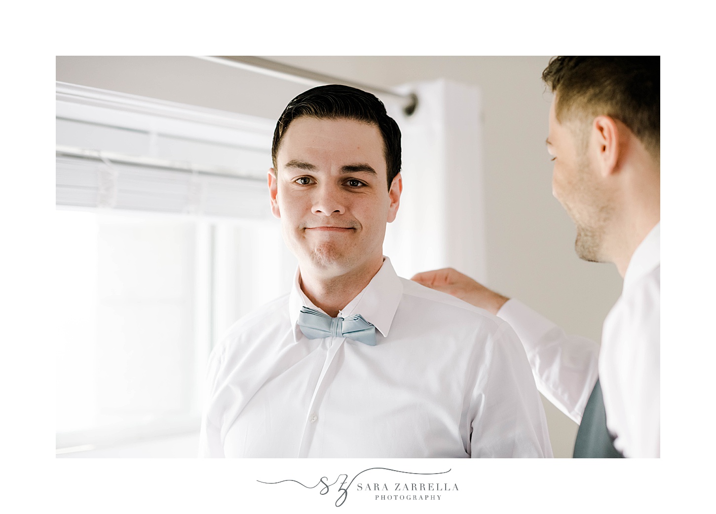 groomsman pats groom on the shoulder at OceanCliff Hotel