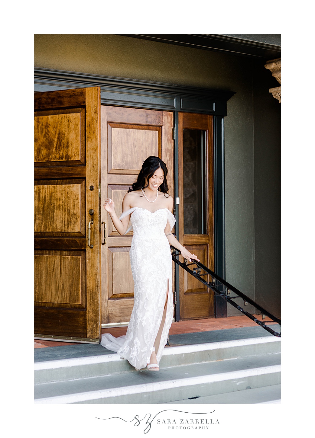 bride walks down steps out of wooden doors at OceanCliff Hotel