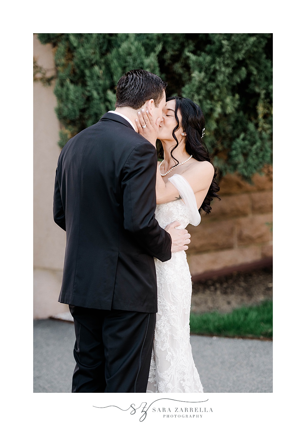 bride kisses groom hugging him during OceanCliff Hotel wedding day
