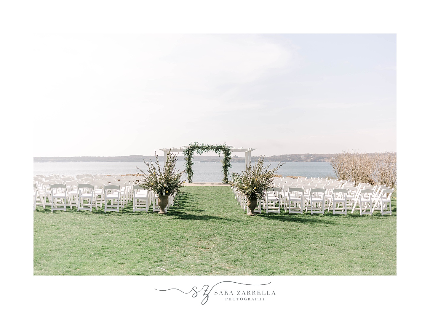wedding ceremony on lawn by water at OceanCliff Hotel