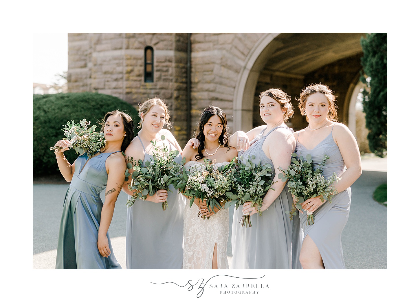 bride and bridesmaids pose with greenery and succulent bouquets at OceanCliff Hotel