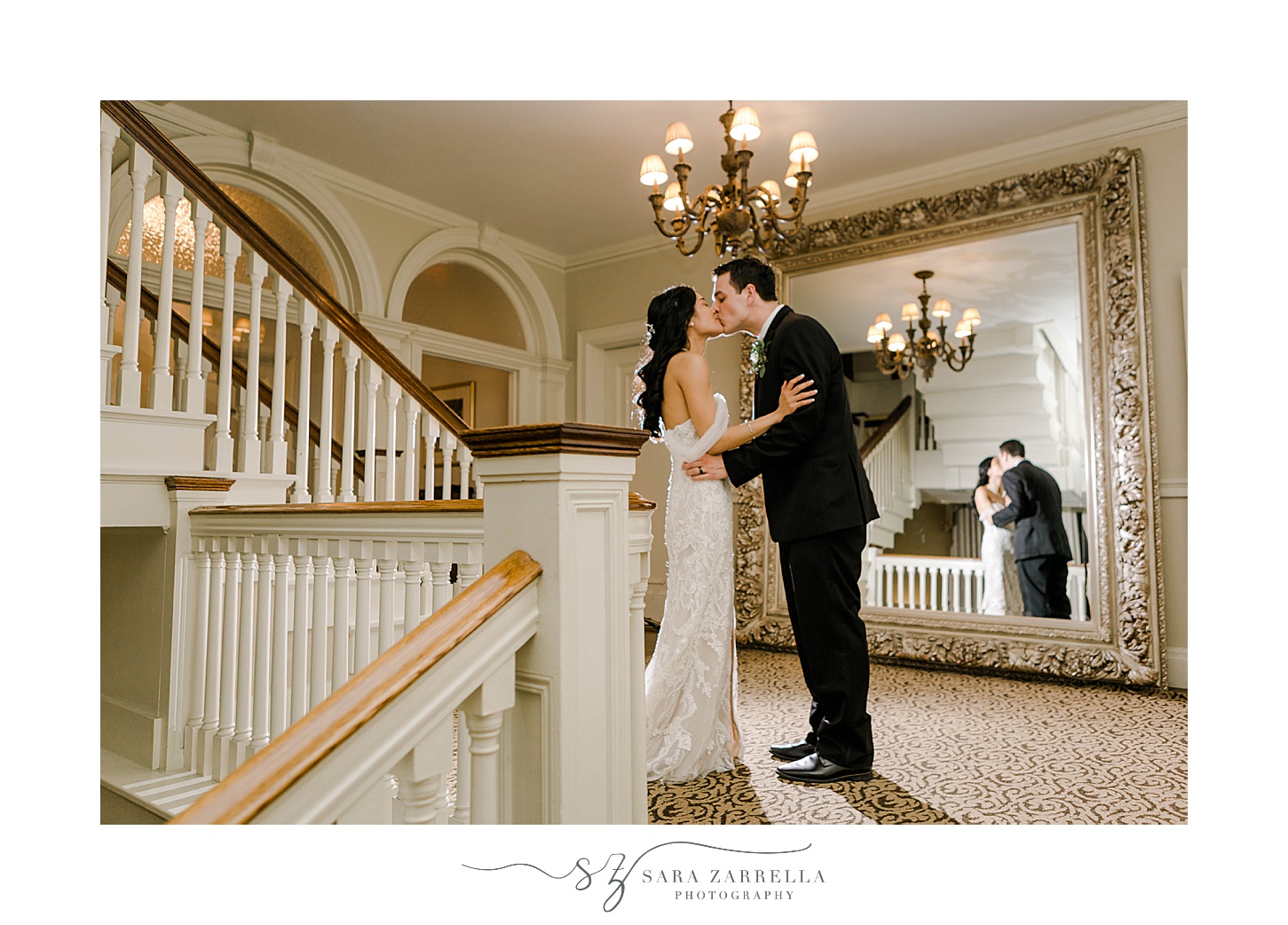bride and groom kiss on staircase inside OceanCliff Hotel