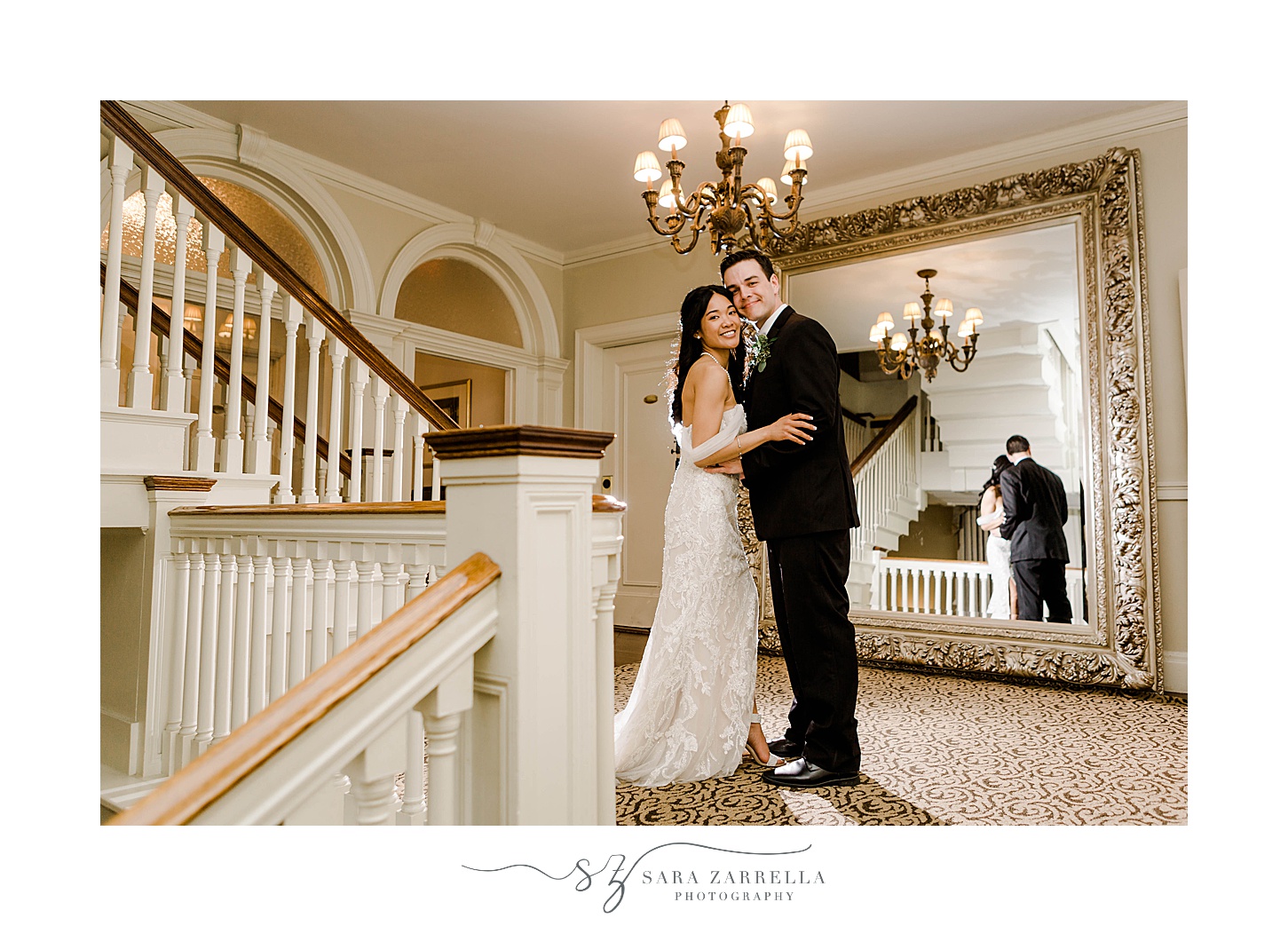 newlyweds hug leaning heads together at OceanCliff Hotel staircase 