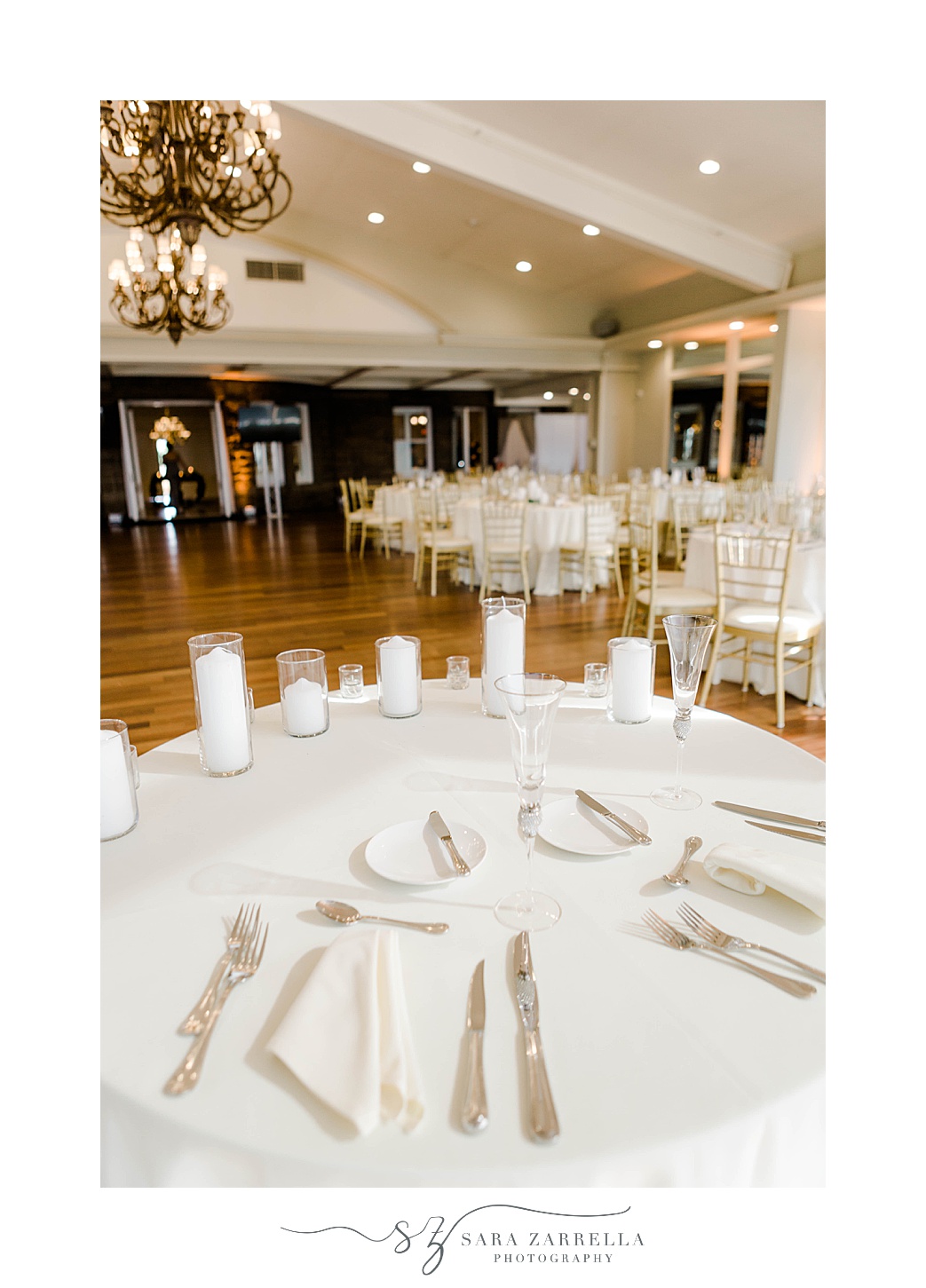 OceanCliff Hotel wedding reception sweetheart table with white napkins and gold silverware 