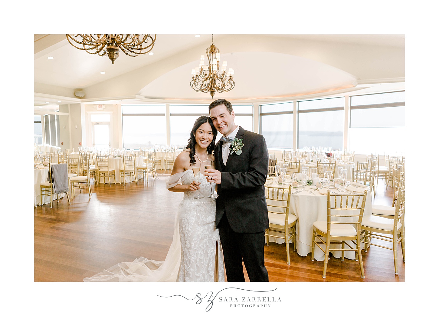bride and groom hug in reception room at OceanCliff Hotel 