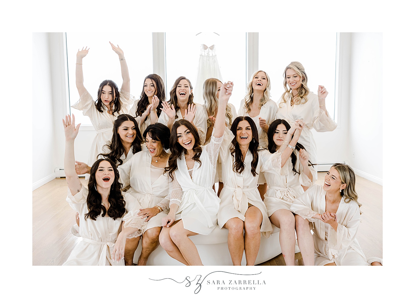 bride and bridesmaids cheer during prep in bridal suite at Belle Mer Island House