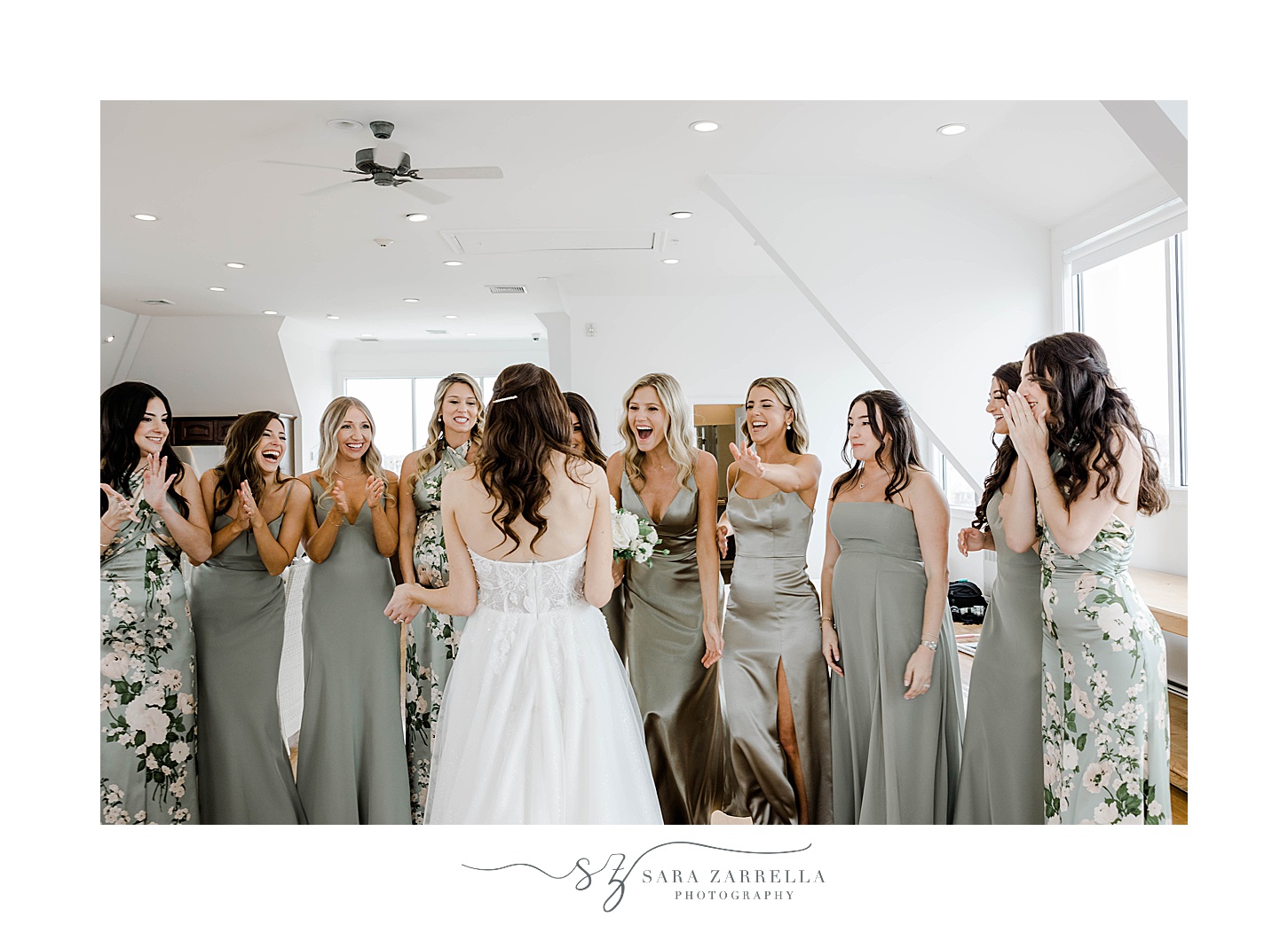 bridesmaids cheer and celebrate bride during first look at Belle Mer Island House