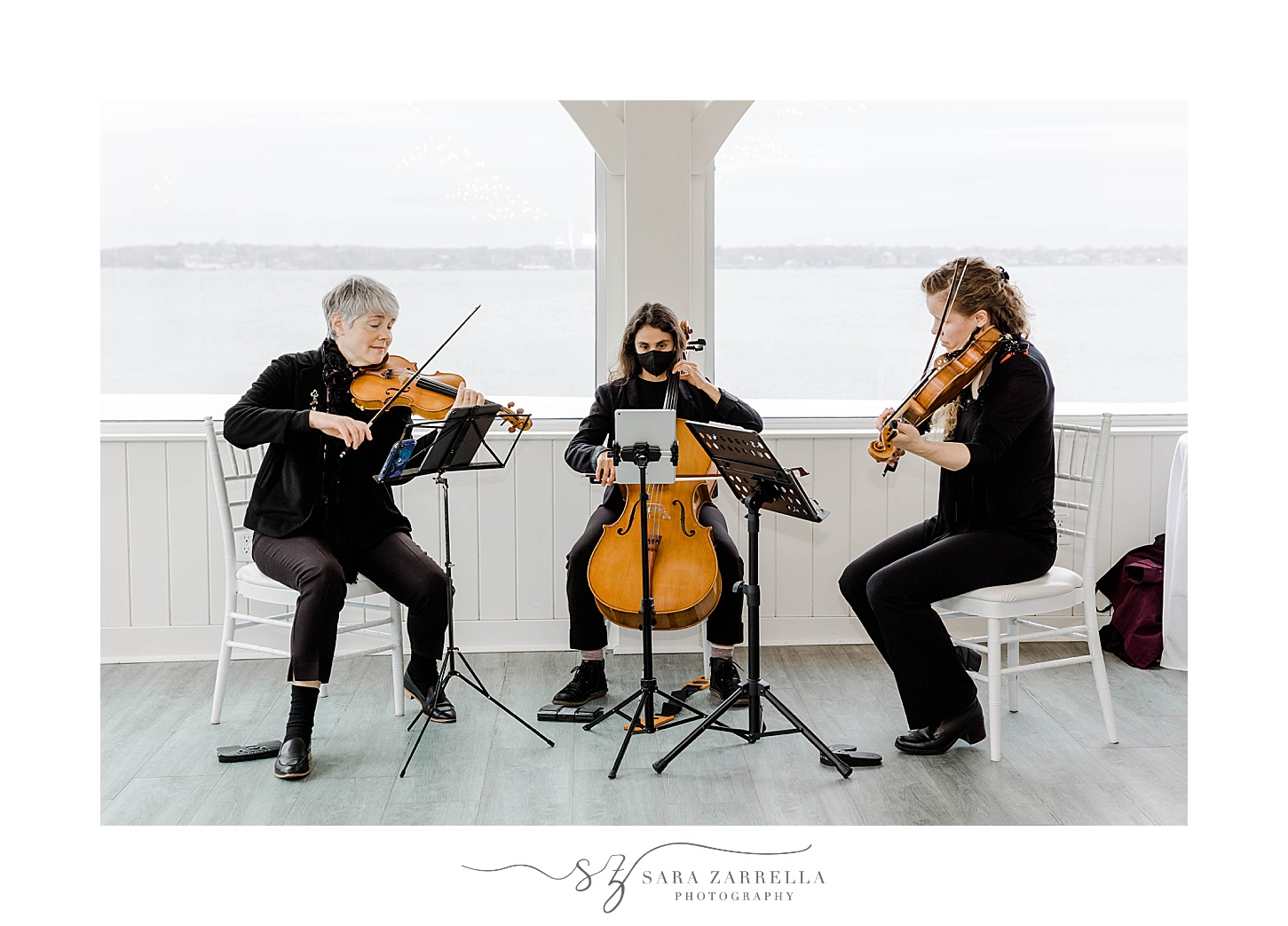 string trio plays on patio at Belle Mer Island House