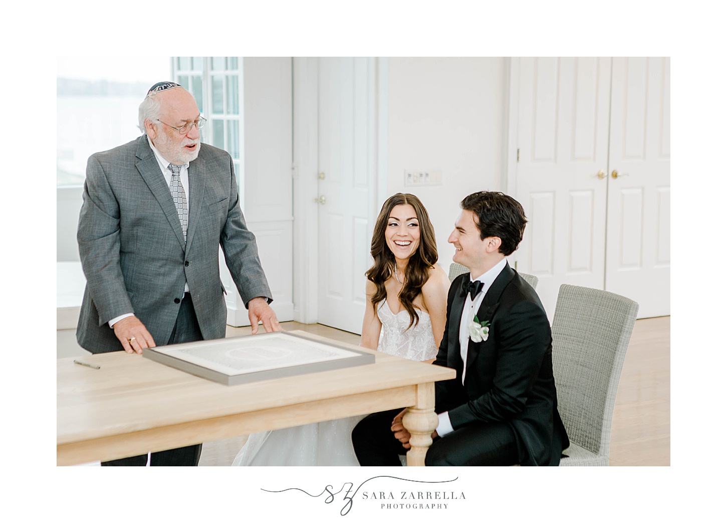 couple listens to Rabbi during Ketubah signing at Belle Mer Island House