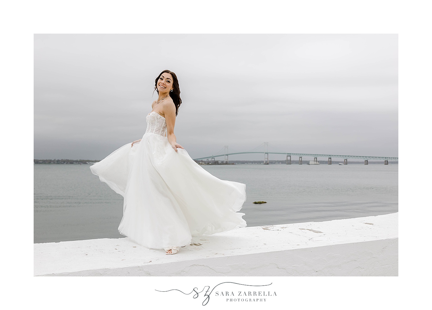 bride twirls in wedding dress on white wall at Belle Mer Island House