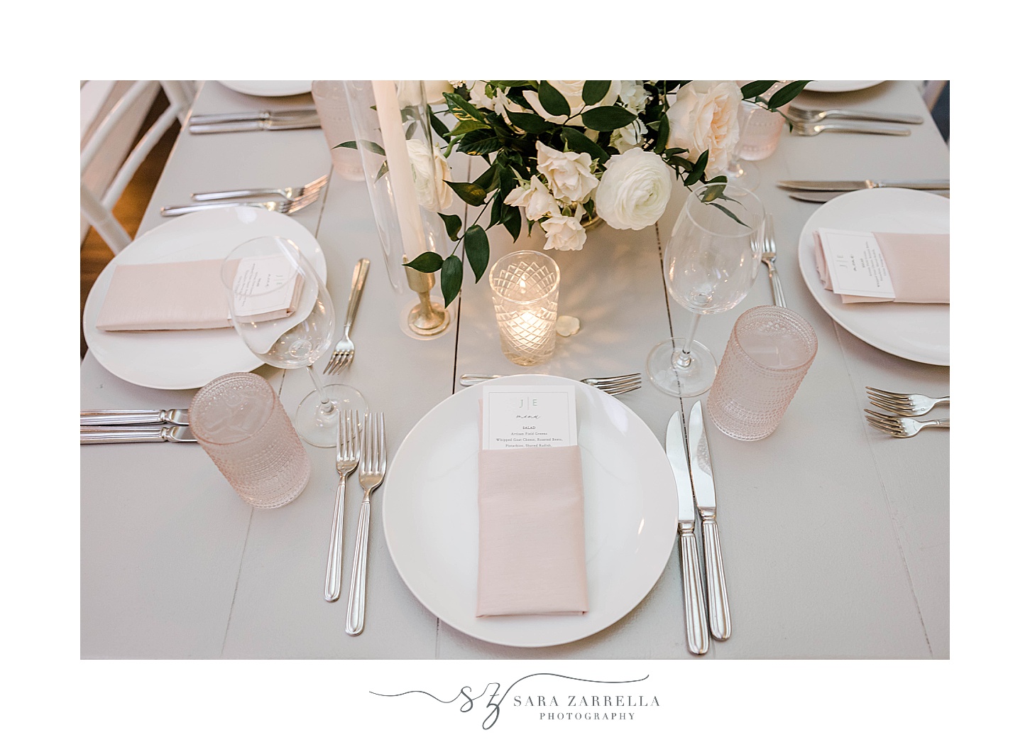 place setting with dusty pink napkins on plates at Belle Mer Island House